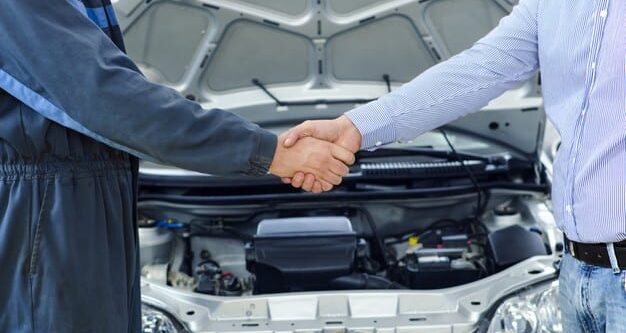 Mechanic and customer shaking hands